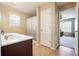 Bright bathroom showcasing a double vanity and a view into a bedroom through an open door at 102 Crescent Woode Way, Dallas, GA 30157