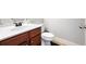 Bathroom with granite countertop, wood cabinets, decorative faucet, and a tiled floor at 102 Crescent Woode Way, Dallas, GA 30157