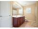 Bathroom featuring a double sink vanity with dark wood cabinets and a shower-tub combo at 102 Crescent Woode Way, Dallas, GA 30157