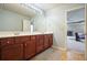 Bathroom with granite countertop, wood cabinets, large mirror and natural light at 102 Crescent Woode Way, Dallas, GA 30157