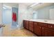 Bathroom with granite countertop, wood cabinets, tiled floor, and neutral paint at 102 Crescent Woode Way, Dallas, GA 30157