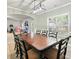 Dining room features traditional seating for eight, a large window, and a view of a bright living space at 102 Crescent Woode Way, Dallas, GA 30157