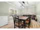 Bright dining room features large window, modern light, and traditional table with seating for eight at 102 Crescent Woode Way, Dallas, GA 30157