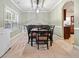 Traditional dining room with a rectangular table set for eight under a modern light fixture at 102 Crescent Woode Way, Dallas, GA 30157