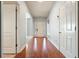 Bright entryway with hardwood floors and white trim, leading to an arched opening to a carpeted room at 102 Crescent Woode Way, Dallas, GA 30157