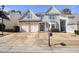 Charming two-story home features a stone-accented facade, a two car garage and well-manicured landscaping at 102 Crescent Woode Way, Dallas, GA 30157