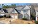 Charming home with stone accents, a two-car garage, and a landscaped yard at 102 Crescent Woode Way, Dallas, GA 30157