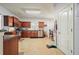Well-lit kitchen featuring tile floors, cherry cabinets, stainless steel appliances, and ample counter space at 102 Crescent Woode Way, Dallas, GA 30157