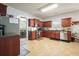 View of open kitchen connecting to other living spaces, featuring cherry cabinets and stainless steel appliances at 102 Crescent Woode Way, Dallas, GA 30157