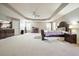 Spacious main bedroom featuring tray ceiling, large windows, and elegant furnishings at 102 Crescent Woode Way, Dallas, GA 30157