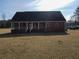 Back exterior showcasing a well-maintained brick exterior and a welcoming covered patio at 172 Lakeview Dr, Newborn, GA 30056