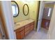 Bathroom featuring a double vanity with mirrors and tiled floor at 172 Lakeview Dr, Newborn, GA 30056