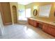Bathroom with soaking tub, tile floors, built-in shelves, and vanity with double sinks at 172 Lakeview Dr, Newborn, GA 30056