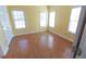 Bedroom with wood-look flooring, light yellow walls, and plenty of natural light at 172 Lakeview Dr, Newborn, GA 30056
