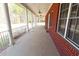 Wide porch featuring brick siding, white columns, and fan lighting at 172 Lakeview Dr, Newborn, GA 30056