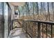 Balcony view of a wooded area with a railing, sliding glass door, and greenery at 3110 Pine Heights Ne Dr, Atlanta, GA 30324