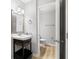 Well-lit bathroom with black vanity, a white sink, and modern mirror at 3110 Pine Heights Ne Dr, Atlanta, GA 30324