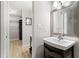 Bathroom featuring a black vanity, a white sink, and a well-organized walk-in closet at 3110 Pine Heights Ne Dr, Atlanta, GA 30324