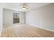 Well-lit bedroom featuring wood-look floors, ceiling fan, and a window providing natural light at 3110 Pine Heights Ne Dr, Atlanta, GA 30324