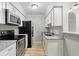 Modern kitchen with stainless steel appliances, granite countertops, and white cabinetry providing a sleek cooking space at 3110 Pine Heights Ne Dr, Atlanta, GA 30324