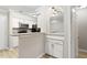 Charming kitchen featuring granite countertops, white cabinets, and a breakfast bar, creating an inviting and functional space at 3110 Pine Heights Ne Dr, Atlanta, GA 30324