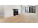 Bright living room featuring a marble fireplace, wood-look floors, and sliding glass doors at 3110 Pine Heights Ne Dr, Atlanta, GA 30324
