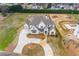 Wide aerial view of the house highlighting the driveway, lawn, and surrounding landscaping at 505 Cochran Dr, Norcross, GA 30071