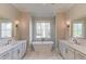Bright bathroom with dual vanities, soaking tub, marble floors, and lots of natural light at 505 Cochran Dr, Norcross, GA 30071
