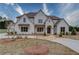 Elegant two-story home with a brick facade, manicured landscaping and a stone walkway at 505 Cochran Dr, Norcross, GA 30071