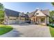 Inviting two-story home featuring a spacious driveway and a charming covered porch at 505 Cochran Dr, Norcross, GA 30071
