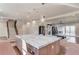 Open-concept kitchen with a large island, marble countertops, stainless steel appliances, and dark cabinets at 505 Cochran Dr, Norcross, GA 30071