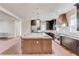 Spacious kitchen with a large island, marble countertops, stainless steel appliances, and dark cabinets at 505 Cochran Dr, Norcross, GA 30071