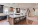 Modern kitchen with a large island, marble countertops, stainless steel appliances, and dark cabinets at 505 Cochran Dr, Norcross, GA 30071