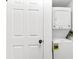 Compact laundry area with a stacked washer and dryer unit, conveniently located near a door at 199 14Th Ne St # 2312, Atlanta, GA 30309