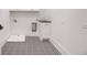 Well-lit laundry room featuring black and white checkered tile floors and shaker style cabinet at 244 Brooke Dr, Alpharetta, GA 30009