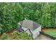 Aerial view of home, highlighting the back yard, deck and wooded, natural surroundings of the property at 6225 Leeward Tide Ct, Cumming, GA 30041