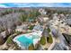 Aerial view showcases the home's private pool and surrounding mature landscaping in an established neighborhood at 6225 Leeward Tide Ct, Cumming, GA 30041