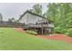Spacious backyard with lush landscaping, a deck, patio, and partial fence at 6225 Leeward Tide Ct, Cumming, GA 30041