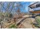 Backyard view from the under deck patio showing seating area, privacy fence, and wooded area at 6225 Leeward Tide Ct, Cumming, GA 30041