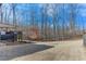 Large backyard with a deck and mature trees at 6225 Leeward Tide Ct, Cumming, GA 30041