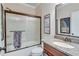 Bathroom with a tub and shower combination, granite countertop, and decorative wall art at 6225 Leeward Tide Ct, Cumming, GA 30041