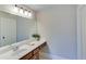 Well-lit bathroom with a large mirror and a white countertop at 6225 Leeward Tide Ct, Cumming, GA 30041