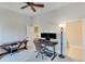 This carpeted bedroom includes an ceiling fan, desk with computer and a standing lamp at 6225 Leeward Tide Ct, Cumming, GA 30041