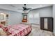 Bedroom with a bed, desk, and wardrobe and a bathroom located in the background at 6225 Leeward Tide Ct, Cumming, GA 30041