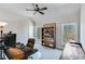 Comfortable home office or bedroom with vaulted ceilings, fan, and natural light from large windows at 6225 Leeward Tide Ct, Cumming, GA 30041