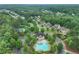 Aerial view of the community pool and tennis courts in neighborhood at 6225 Leeward Tide Ct, Cumming, GA 30041