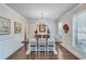 A beautifully decorated dining room featuring a wooden table, elegant chandelier, and plantation shutters at 6225 Leeward Tide Ct, Cumming, GA 30041