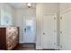 Welcoming entryway with hardwood floors, a wooden storage unit, and doors leading to various rooms at 6225 Leeward Tide Ct, Cumming, GA 30041