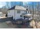 Rear exterior of house with a deck, patio and lush wooded backyard providing privacy and a scenic view at 6225 Leeward Tide Ct, Cumming, GA 30041