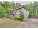 This lovely two-story home features a mix of brick and siding, enhanced by lush landscaping and a well-kept lawn at 6225 Leeward Tide Ct, Cumming, GA 30041
